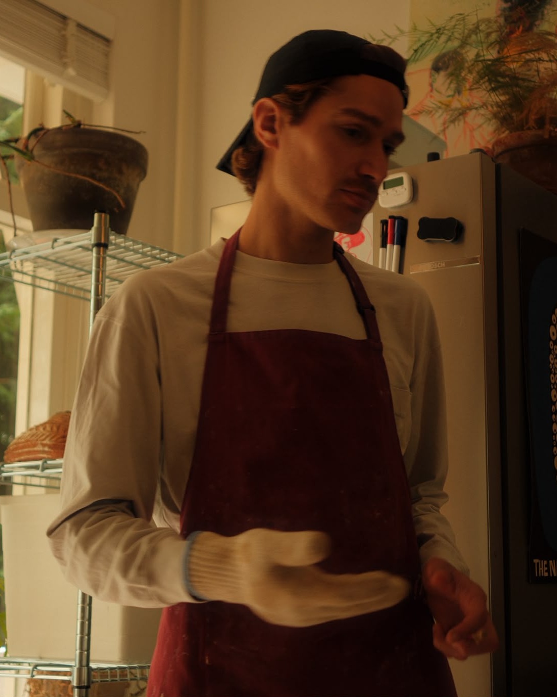 Fabrizio at work in the bakery, in his red apron